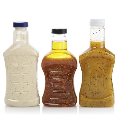 Collection of three unbranded salad dressing bottles
